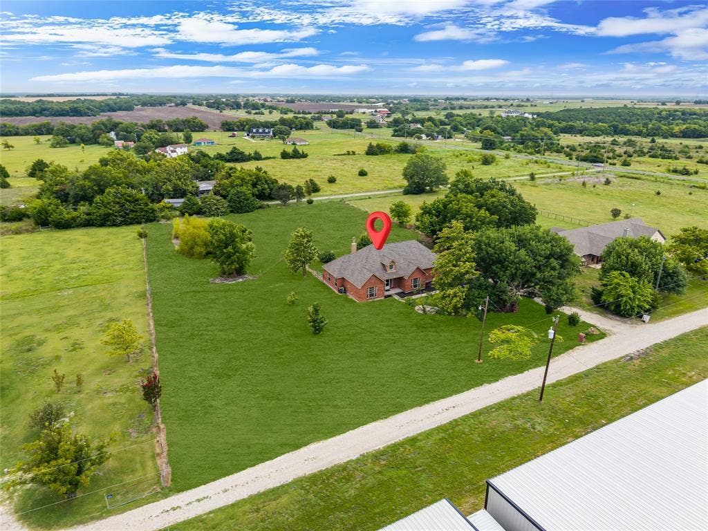 18723 Sims Lane, Nevada, TX 75173 Red brick residence situated on a large grassy parcel