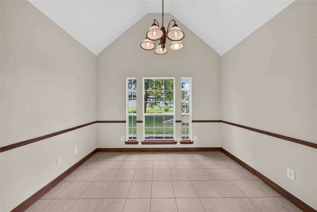 18723 Sims Lane, Nevada, TX 75173 Formal dining space featuring a vaulted ceiling and tile flooring