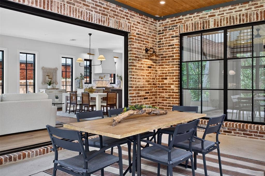 6817 Blessing Drive, Dallas, TX 75214 Outdoor dining space featuring exposed brick walls and a wood plank ceiling