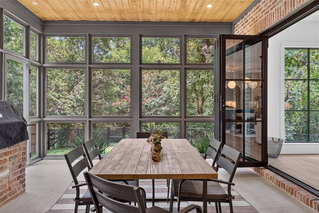6817 Blessing Drive, Dallas, TX 75214 Screened porch featuring a wood-plank ceiling, concrete flooring, and extensive multi-pane windows
