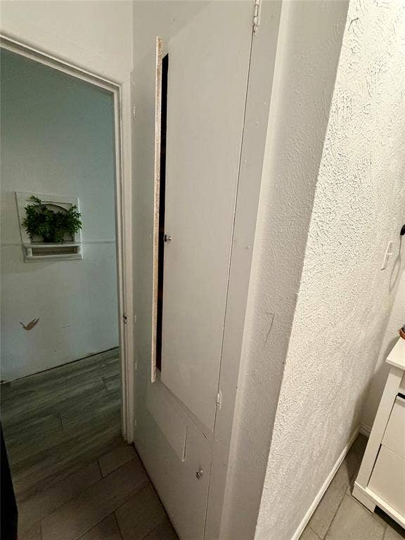 Linen cabinet with built in clothes hamper in secondary bathroom