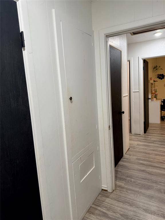 Storage cabinet in primary bedroom with clothes hamper