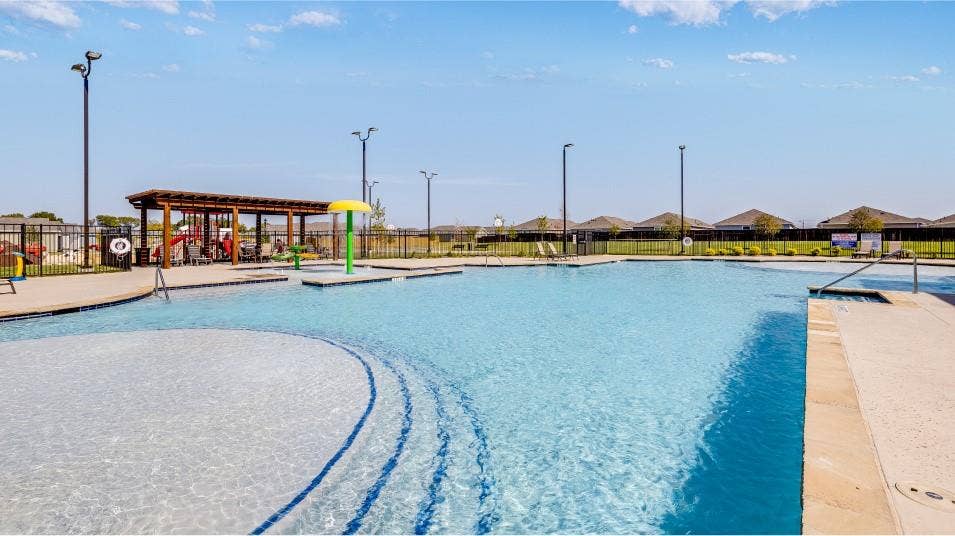 6307 Sandpiper Lane, Princeton, TX 75407 Expansive community swimming pool featuring a tanning ledge with stepped entry, an in-pool play structure, and a covered pergola with seating