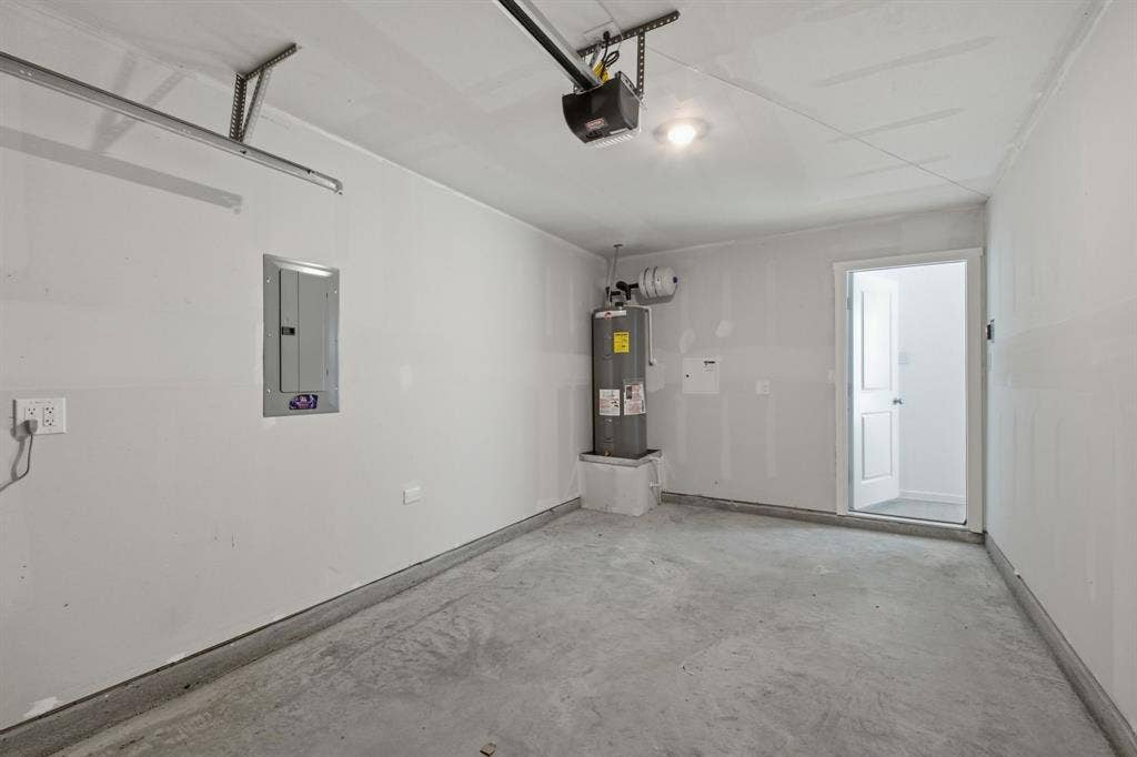 6307 Sandpiper Lane, Princeton, TX 75407 Attached garage space featuring a concrete floor, painted walls, and an overhead garage door track system