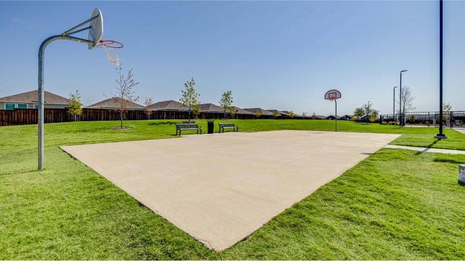 6307 Sandpiper Lane, Princeton, TX 75407 Outdoor basketball court featuring a concrete playing surface, two hoops, and surrounding manicured green space