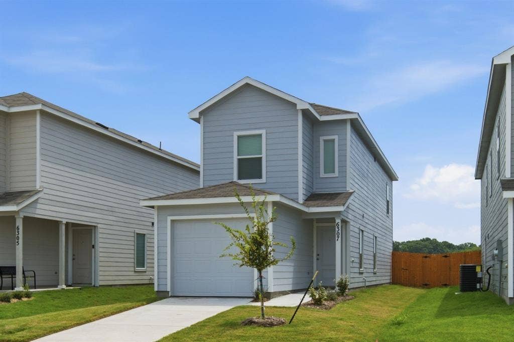 6307 Sandpiper Lane, Princeton, TX 75407 Two-story property featuring light blue siding, an attached single-car garage, and a concrete driveway
