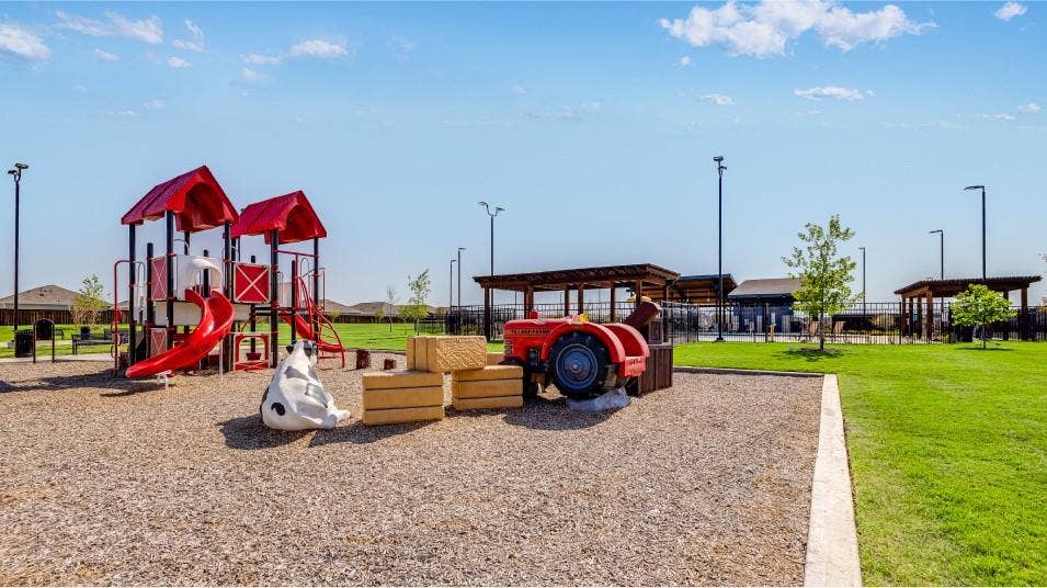 6307 Sandpiper Lane, Princeton, TX 75407 Community playground featuring a multi-level play structure with red slides, a tractor-themed play element, and a cow-shaped spring rider