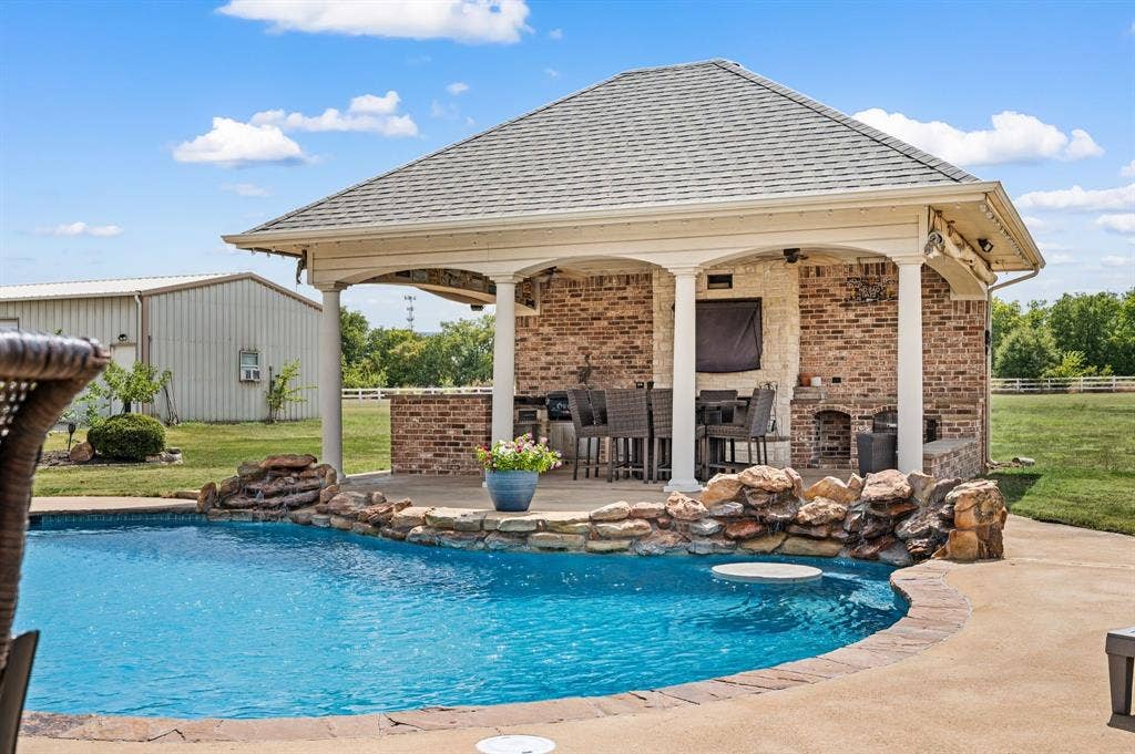13425 Willow Creek Drive, Haslet, TX 76052 Sparkling pool with beach entry, bar table • Cabana filled with features