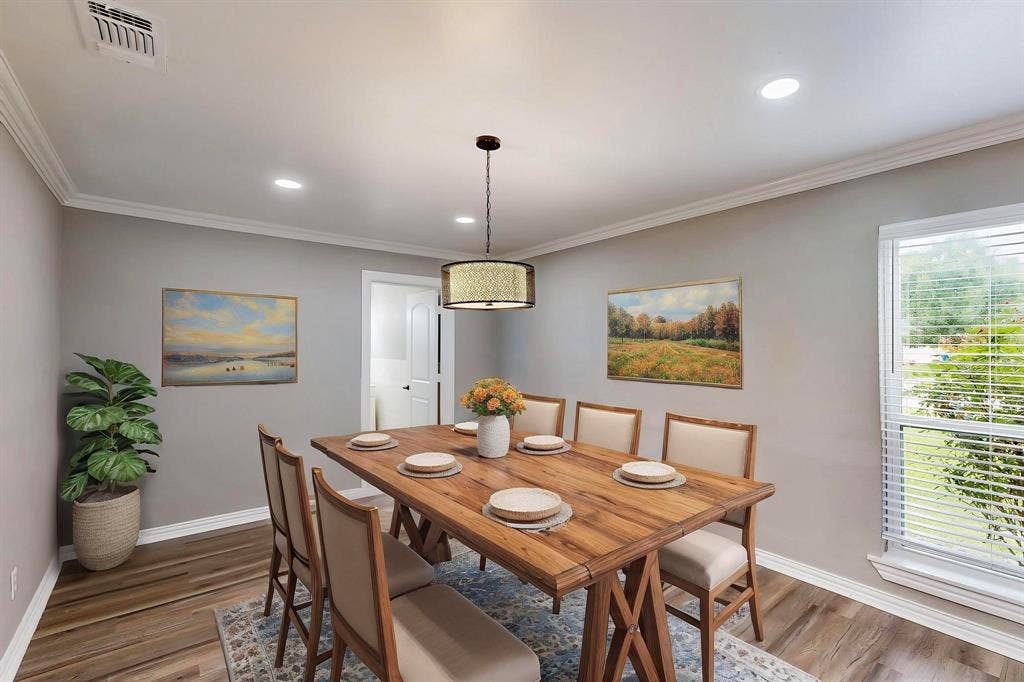 *Virtually staged*  Dining room with wood finished floors, baseboards, ornamental molding, and recessed lighting