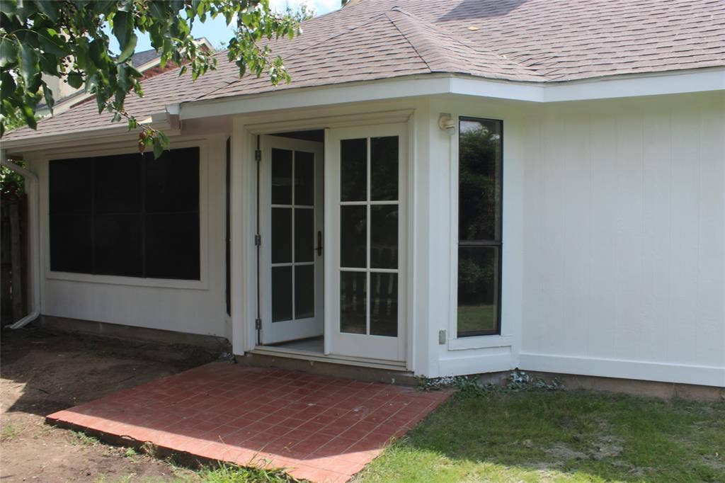 285 Alex Drive, Coppell, TX 75019 Exterior featuring French doors, a screened window, a vertical window, white siding, and a partial shingle roof