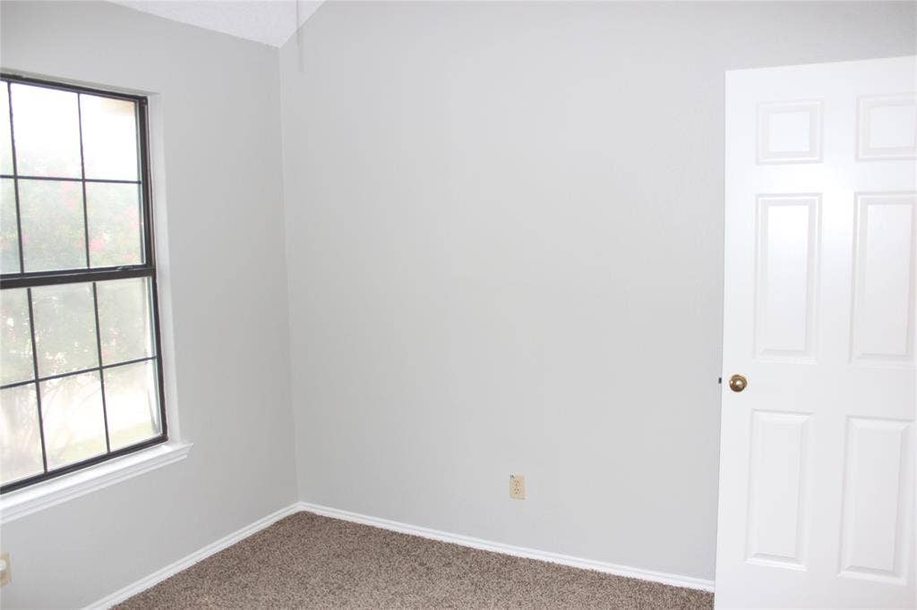 285 Alex Drive, Coppell, TX 75019 Bright interior space featuring a multi-pane window with a black frame and white trim