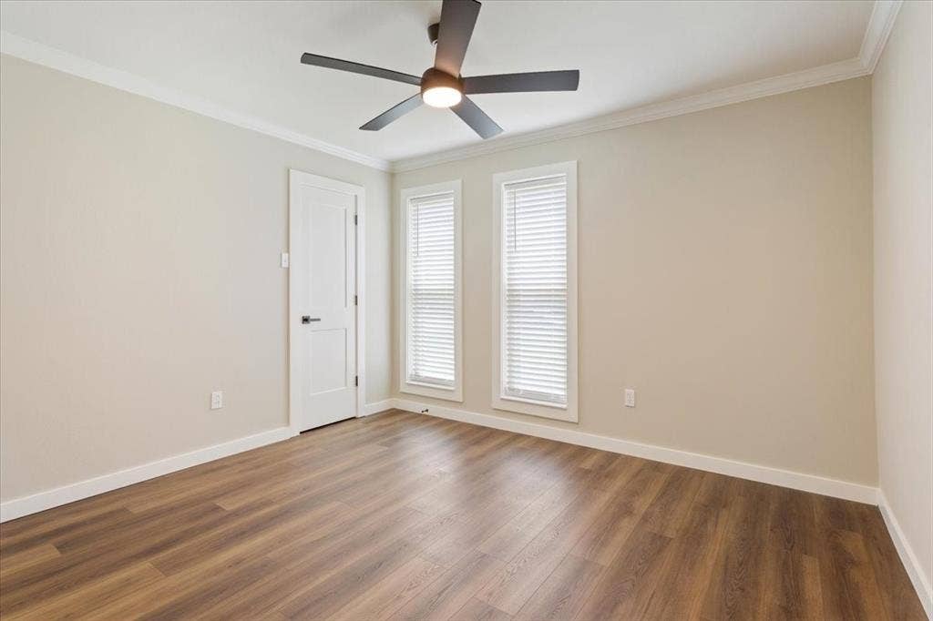 116 Boleman Drive, Hewitt, TX 76643 Spacious bedroom room featuring LVP wood-finish flooring, ample natural light, ceiling fan, light neutral wall paint, and white crown molding