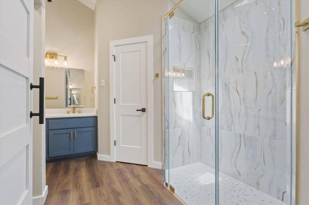 116 Boleman Drive, Hewitt, TX 76643 Walk-in shower with custom made glass enclosure, featuring light-toned large format tile walls and a textured shower pan