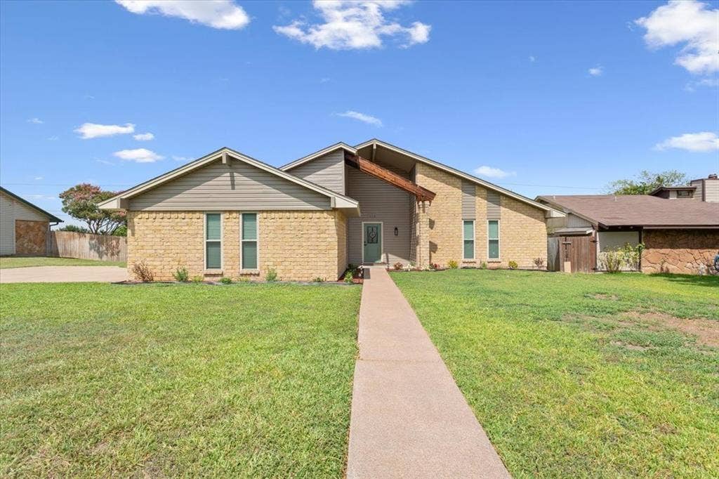 116 Boleman Drive, Hewitt, TX 76643 Brick and siding exterior featuring a prominent gabled roofline and a light blue entry door