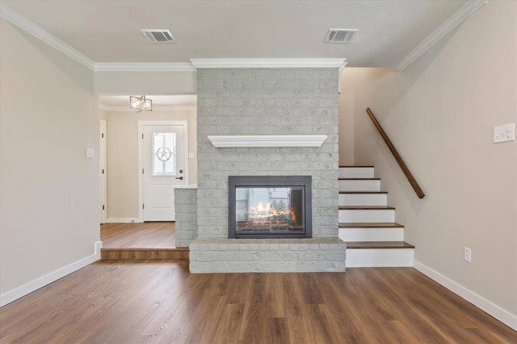 116 Boleman Drive, Hewitt, TX 76643 Central fireplace with a painted brick surround, glass doors, and white mantel