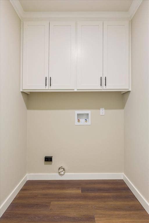 116 Boleman Drive, Hewitt, TX 76643 Dedicated laundry area featuring overhead white shaker-style cabinetry with matte black hardware, LVP wood-finish flooring, and white baseboards