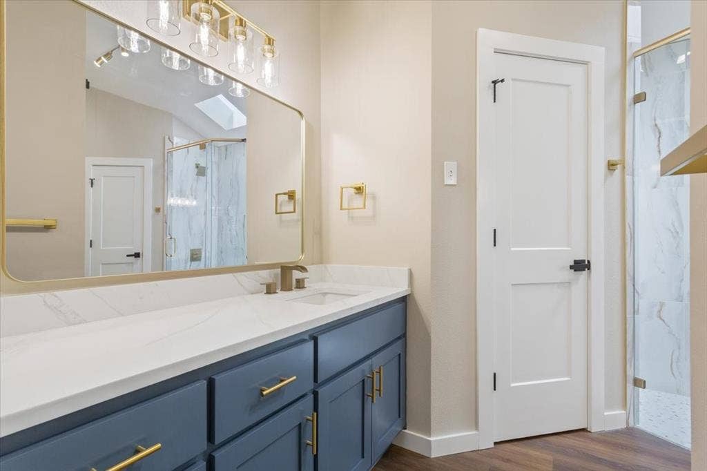 116 Boleman Drive, Hewitt, TX 76643 Primary, ensuite bathroom vanity featuring a white countertop, undermount sink, and blue cabinetry with gold-tone hardware