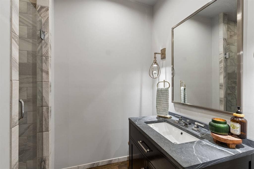6015 Shetland Drive, Dallas, TX 75230 Gorgeous bathroom with soapstone countertop, modern sconces and walk-in shower!