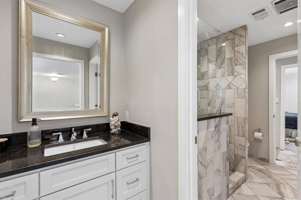 6015 Shetland Drive, Dallas, TX 75230 Another beautifully updated bathroom with pocket doors connecting for privacy.