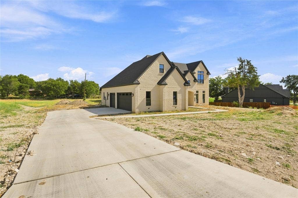 3820 Jacks Loop, Midlothian, TX 76065 Brick exterior with a dark shingle roof, attached two-car garage, and concrete driveway