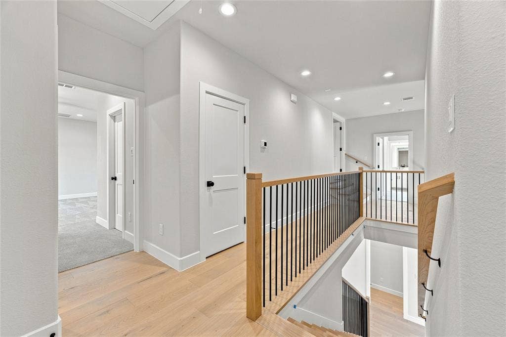 3820 Jacks Loop, Midlothian, TX 76065 Light-toned wood-finish flooring, recessed ceiling lighting, and contemporary stair railing with wood newel posts and black balusters