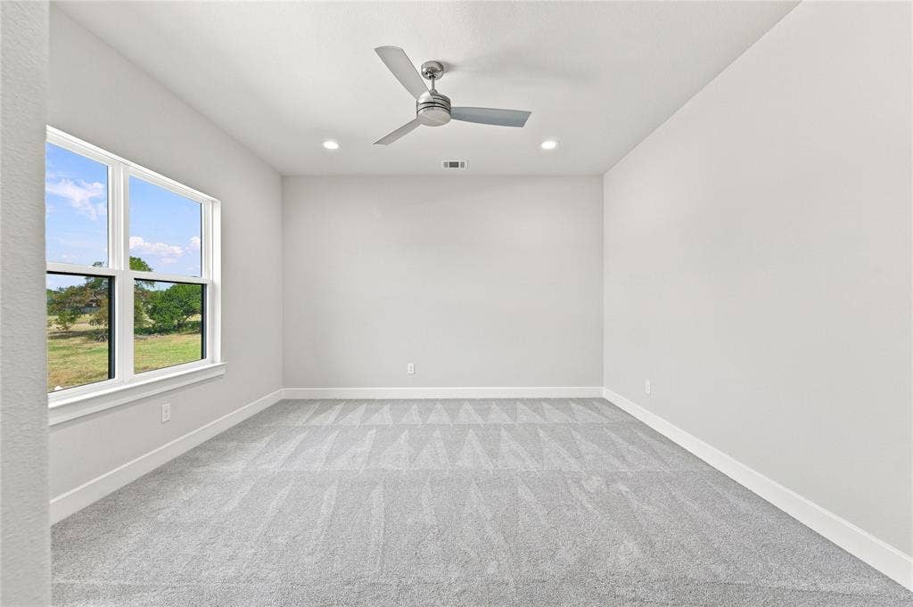 3820 Jacks Loop, Midlothian, TX 76065 Neutral-toned walls, recessed lighting, and a ceiling fan create a comfortable atmosphere