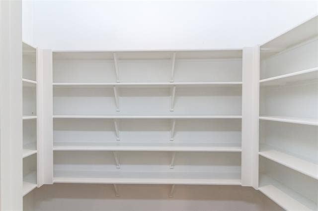 448 Ella Lane, Fate, TX 75087 Built-in shelving system featuring multiple white shelves and vertical supports