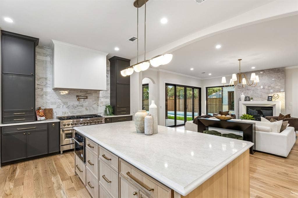 16834 Mossy Oak Drive, Dallas, TX 75248 Chef's kitchen with large center island overlooking the living room and backyard oasis