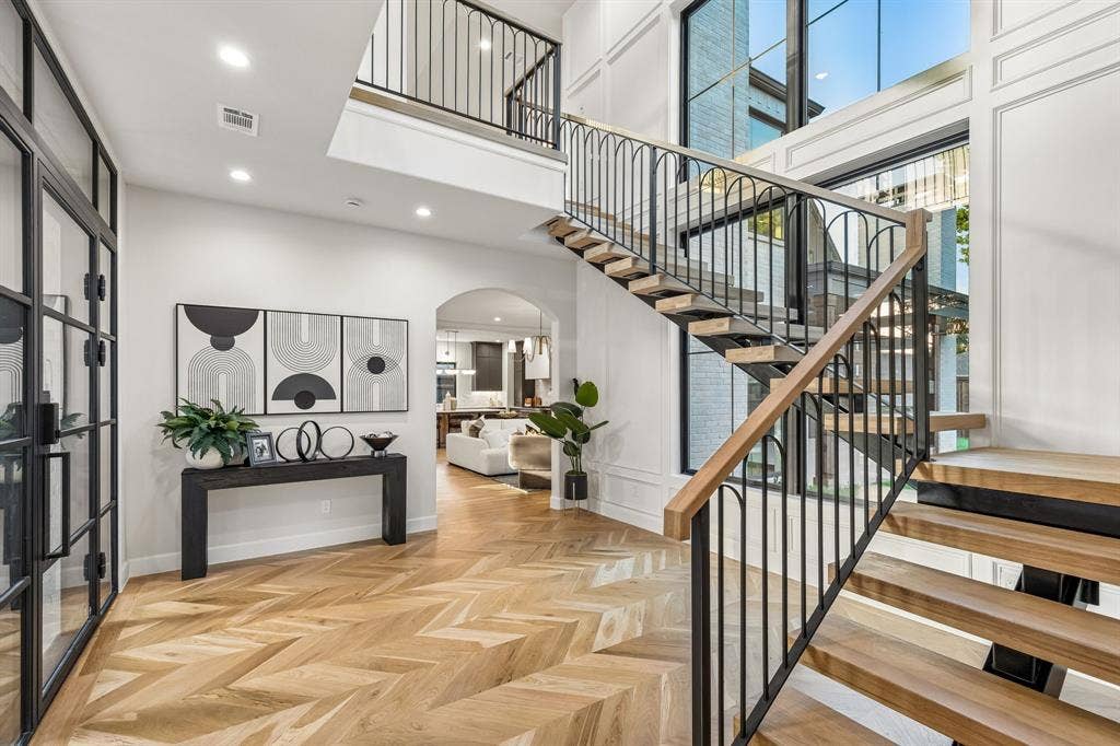 16834 Mossy Oak Drive, Dallas, TX 75248 Entry Foyer with Iron front door, large window that provides natural lighting and an iron staircase with 3 inch white oak treads