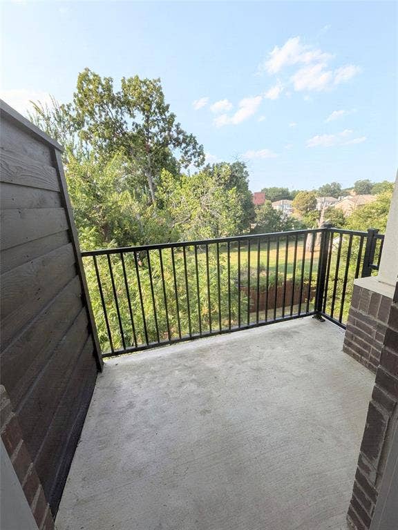 2514 Vintage Street, Farmers Branch, TX 75234 Private primary room en-suite balcony featuring a concrete floor, black metal railing, and a slatted exterior wall