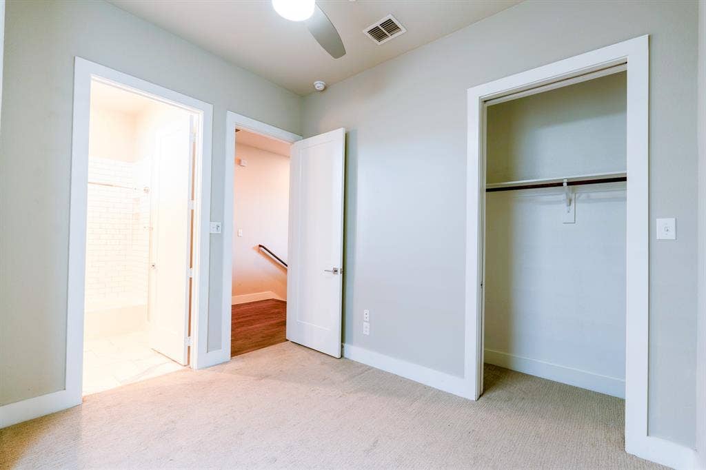 2514 Vintage Street, Farmers Branch, TX 75234 Carpeted room with light gray walls, a ceiling fan, and a recessed vent