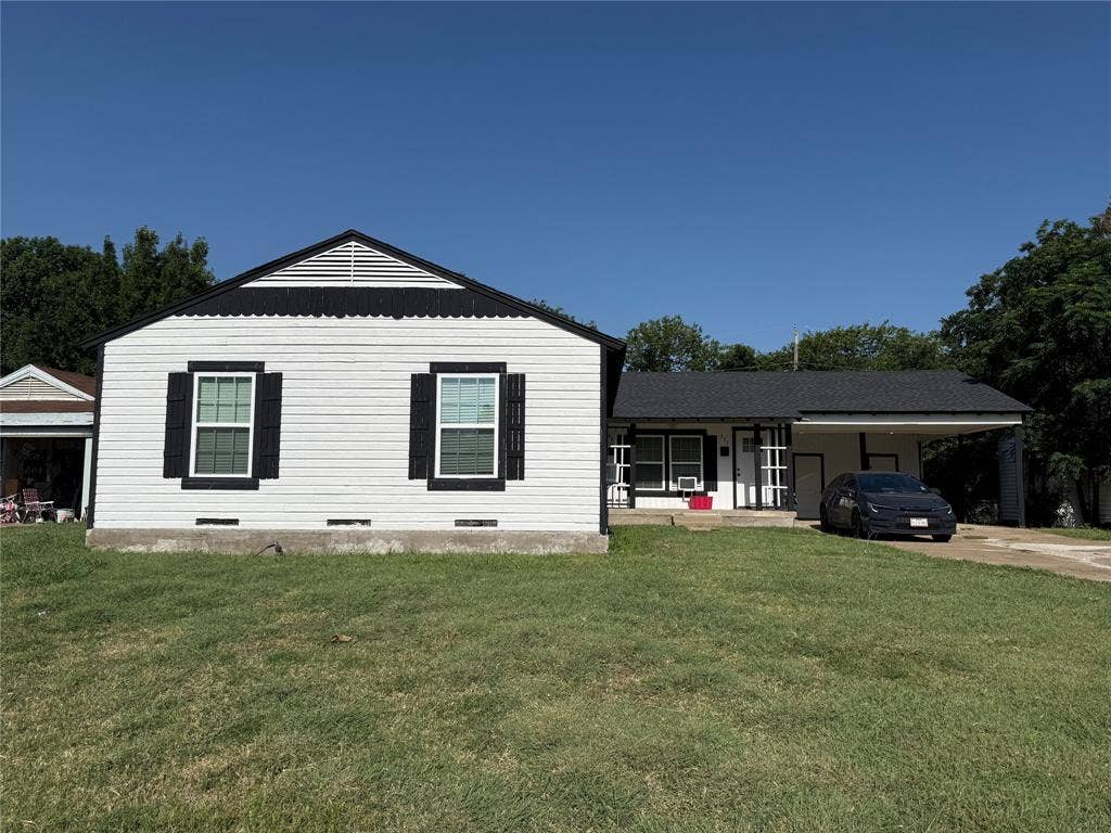 205 22nd Street, Grand Prairie, TX 75050 Single-story residence featuring white siding and a contrasting black roof