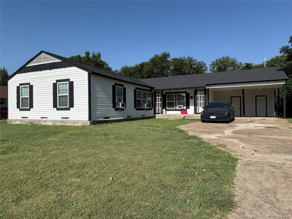 205 22nd Street, Grand Prairie, TX 75050 Exterior featuring white horizontal siding with dark trim, a dark shingle roof, and a covered carport