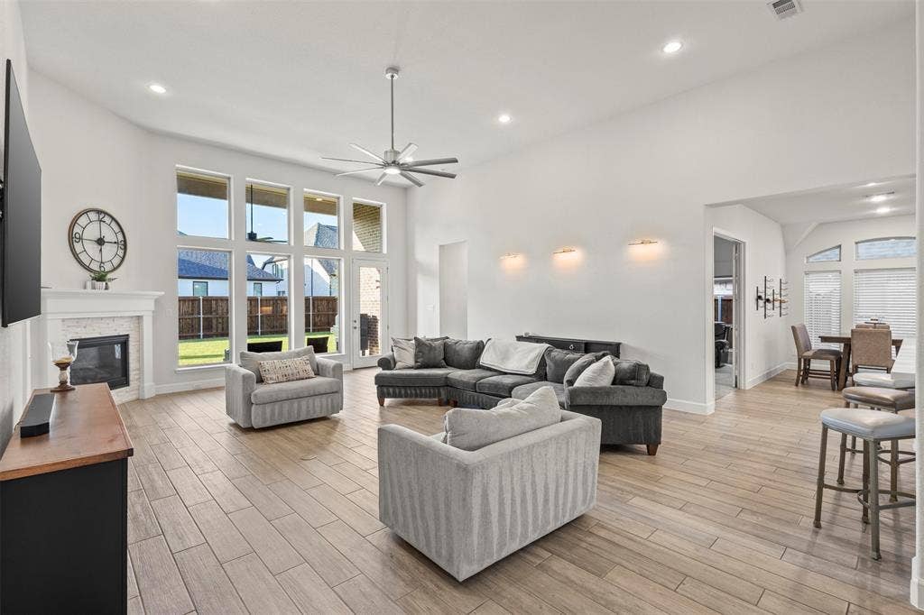 2837 Midlake Drive, Midlothian, TX 76065 Open-concept living space featuring wood-finish flooring, a contemporary ceiling fan, and recessed lighting