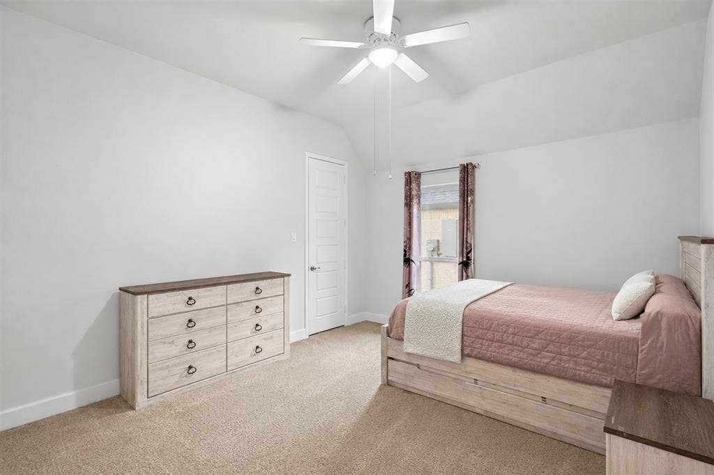 2837 Midlake Drive, Midlothian, TX 76065 Carpeted room with a vaulted ceiling, ceiling fan, and a single window