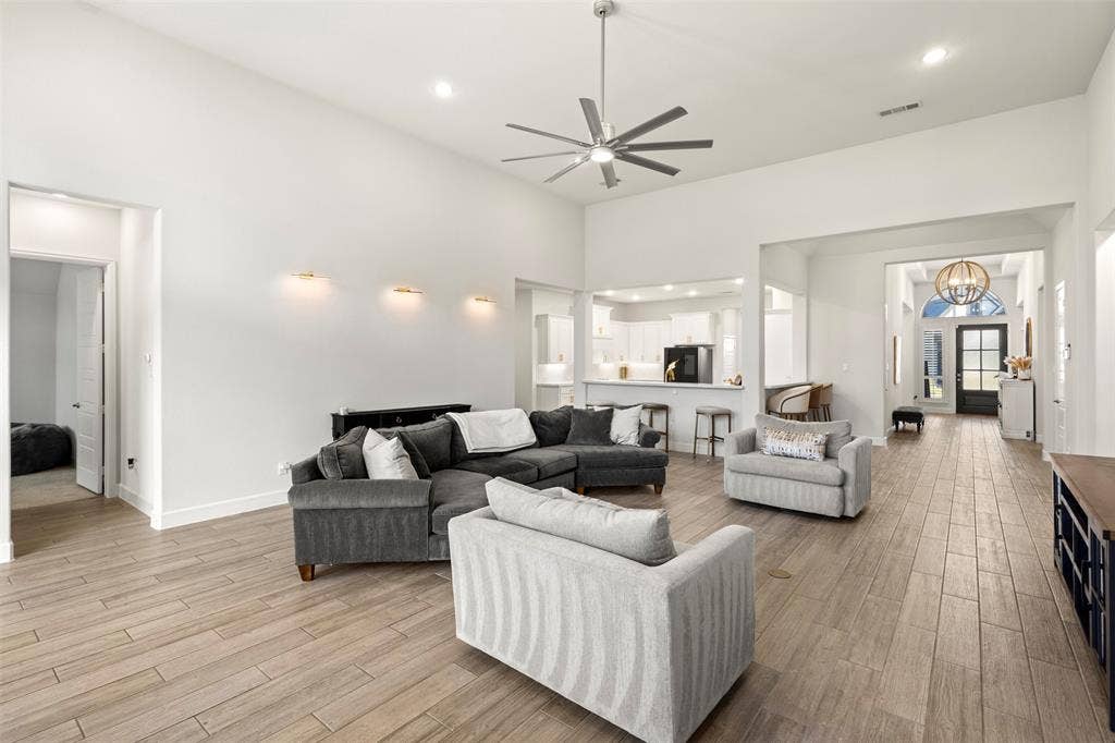 2837 Midlake Drive, Midlothian, TX 76065 Spacious living area featuring high vaulted ceilings, wood-finish flooring, and recessed lighting