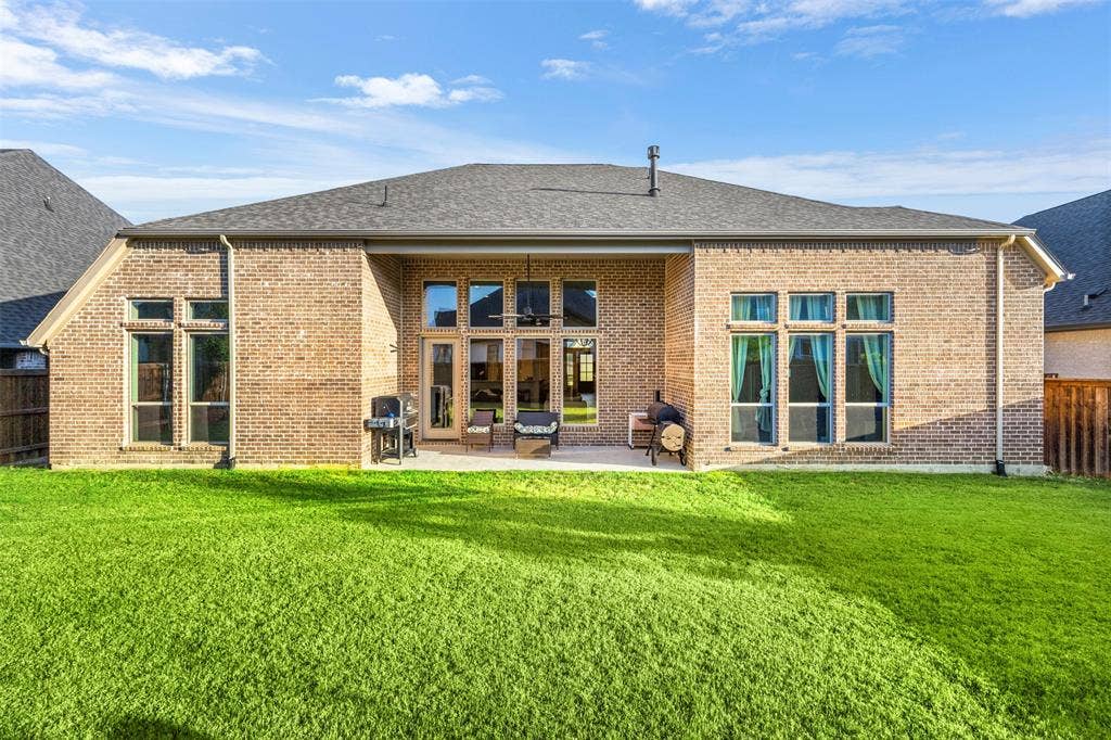 2837 Midlake Drive, Midlothian, TX 76065 Brick exterior featuring a covered patio, expansive lawn, and multiple windows