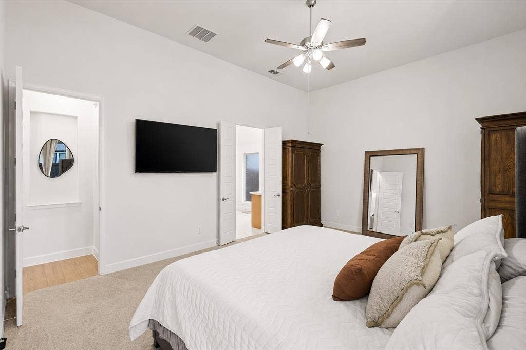2837 Midlake Drive, Midlothian, TX 76065 Spacious bedroom featuring high ceilings, a ceiling fan with light fixture, carpeted flooring, and white walls