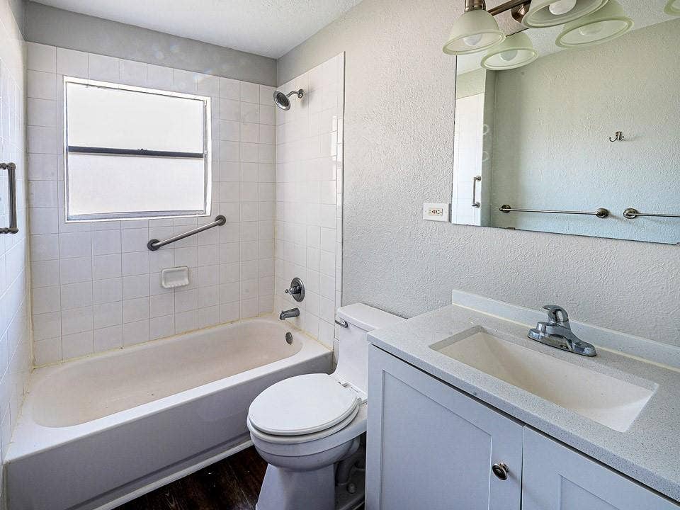 1205 Northridge Drive, Plano, TX 75075 Bathroom featuring a white vanity with a light-colored countertop, an integrated sink, and an overhead vanity light fixture