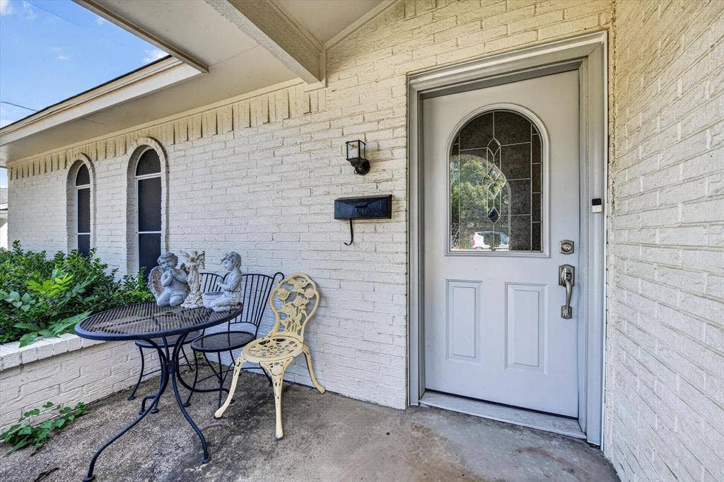 629 Newton Drive, Burleson, TX 76028 White brick exterior featuring a covered entry