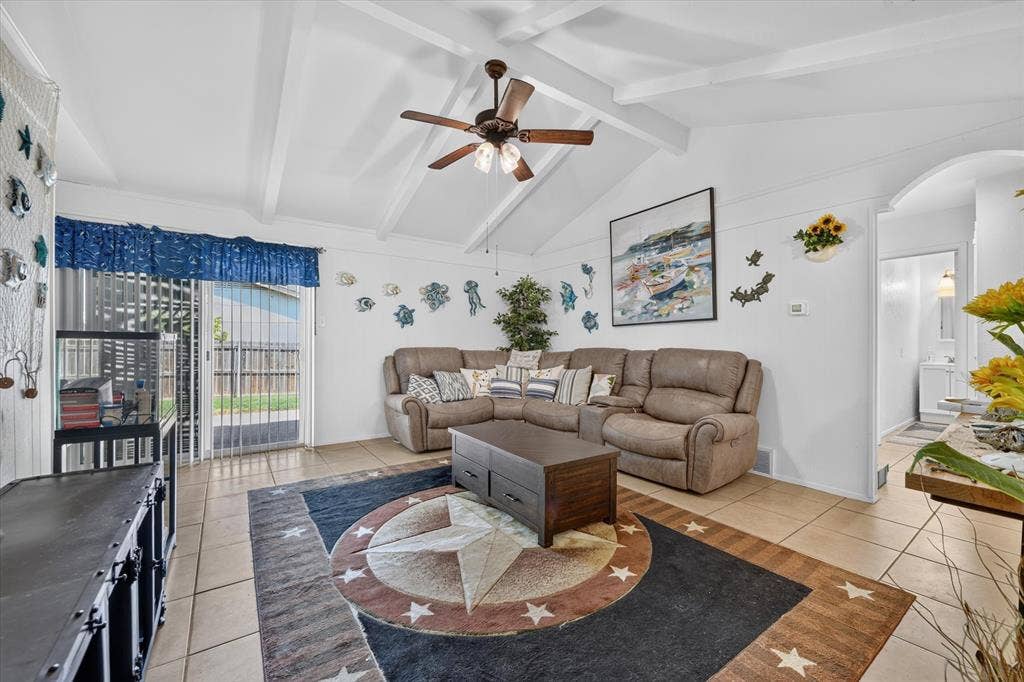 629 Newton Drive, Burleson, TX 76028 Vaulted ceiling with exposed white beams and a ceiling fan
