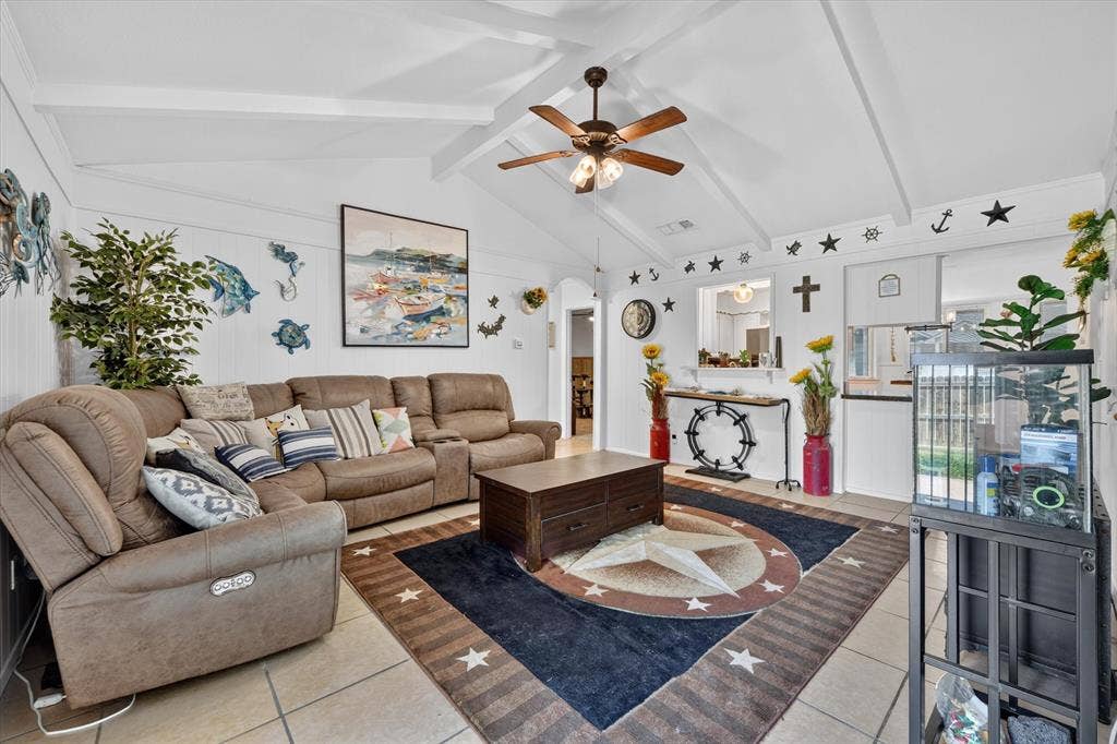 629 Newton Drive, Burleson, TX 76028 Bright, open living area featuring a coffered ceiling with ceiling fan, neutral tile flooring, and a geometric area rug