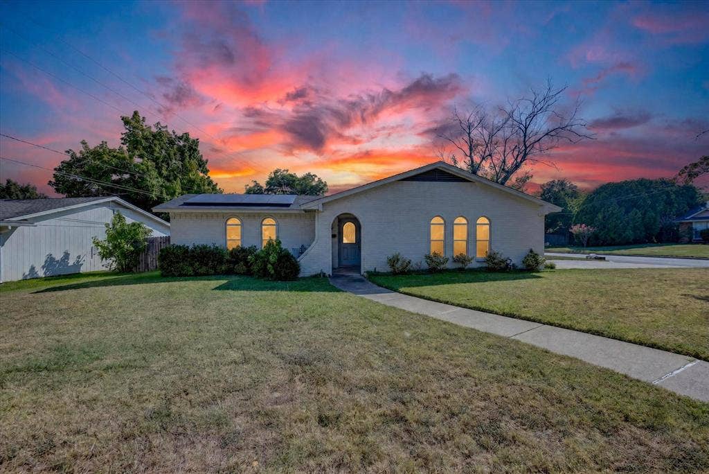 629 Newton Drive, Burleson, TX 76028 Single-story residence featuring a light-colored brick facade and a dark roofline