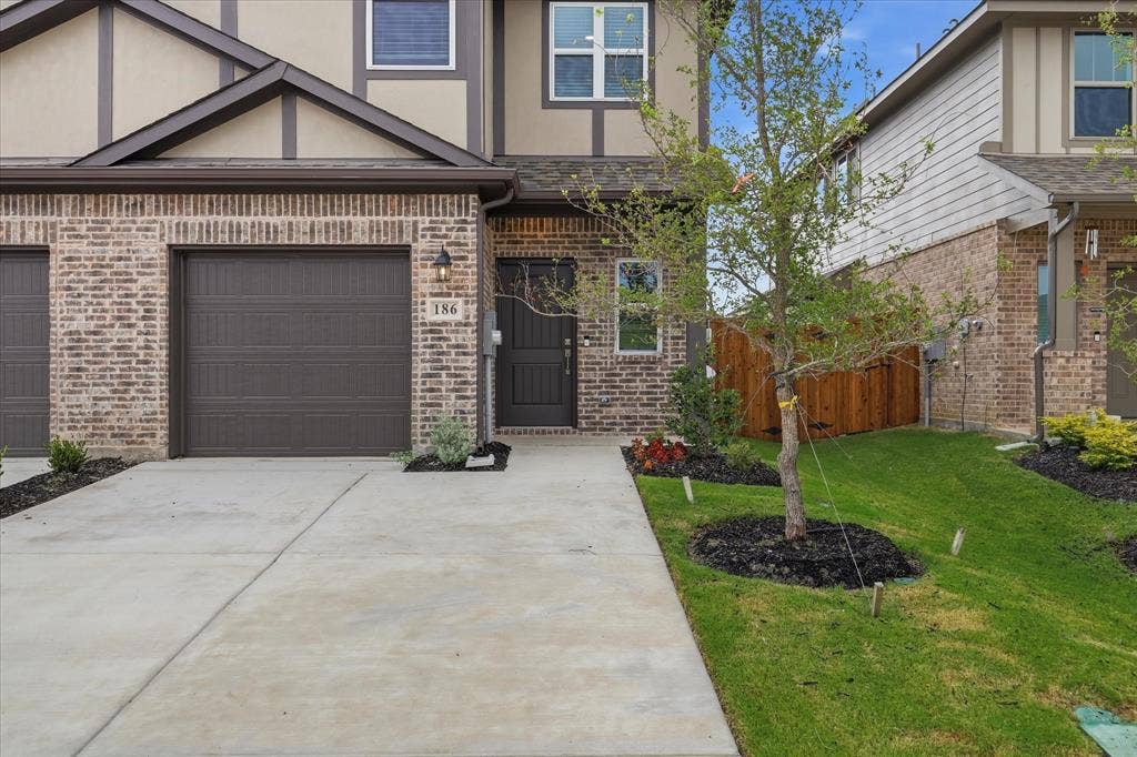 186 Balboa Lane, #8, Princeton, TX 75407 Brick and siding exterior with a dark brown garage door and front door
