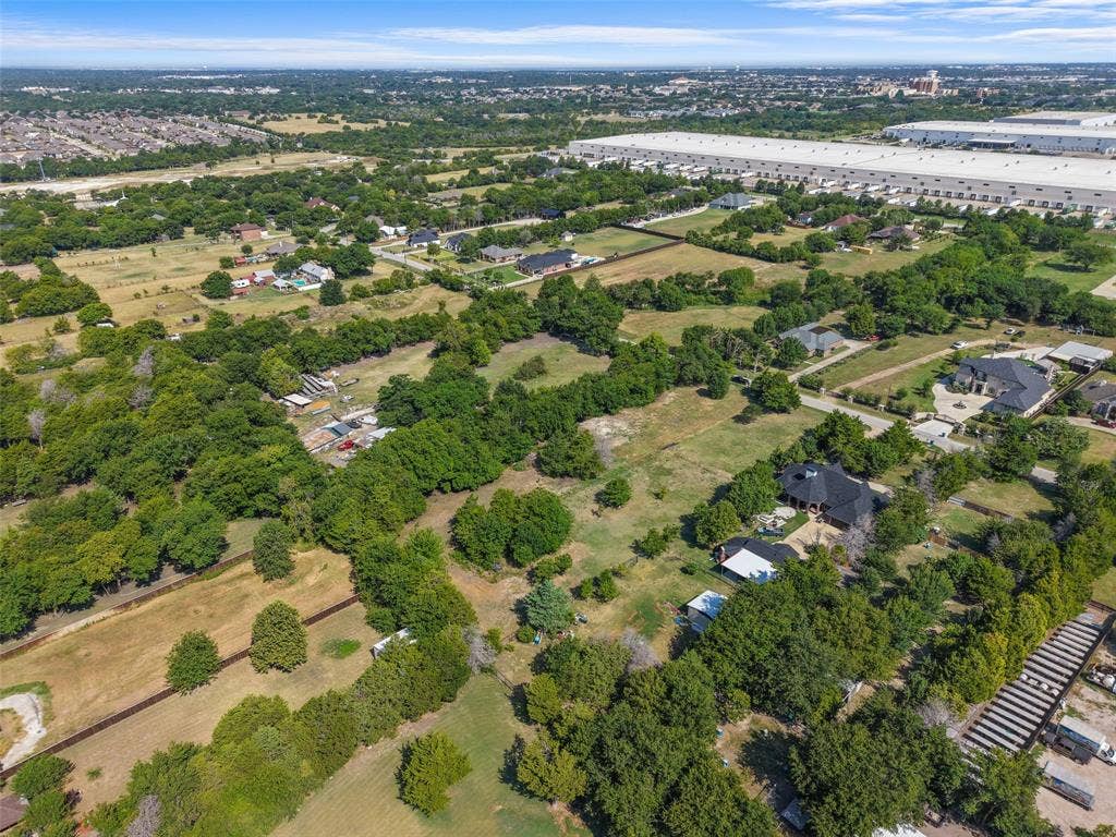 12 Winston Drive, DeSoto, TX 75115 Expansive aerial view showcasing properties nestled among mature trees and open fields