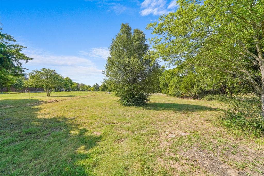12 Winston Drive, DeSoto, TX 75115 Expansive green space featuring mature trees and a clear sky