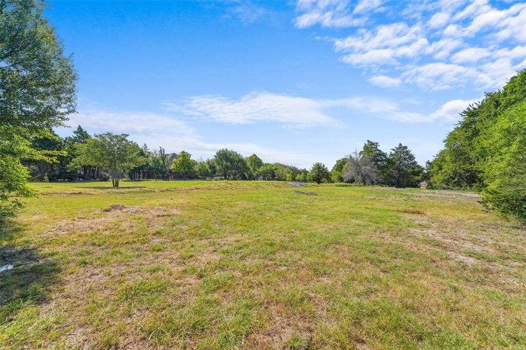 12 Winston Drive, DeSoto, TX 75115 Expansive grassy lot with scattered mature trees and open sky