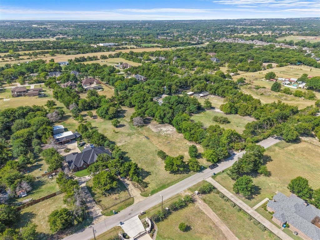 12 Winston Drive, DeSoto, TX 75115 Expansive acreage featuring mature trees and a residential street