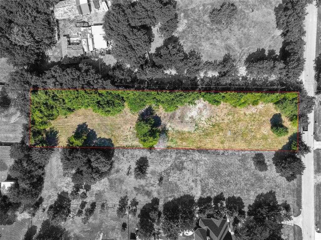 12 Winston Drive, DeSoto, TX 75115 Expansive rectangular land parcel featuring a mix of mature trees and open ground