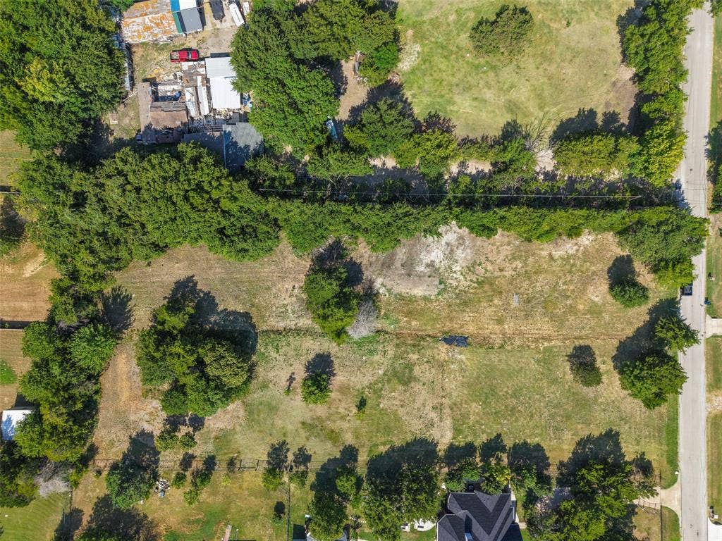 12 Winston Drive, DeSoto, TX 75115 Expansive land parcel featuring a combination of cleared areas and mature trees